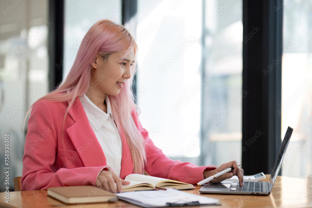 Business woman using calculator for do math finance on wooden desk in office and business working background, tax, accounting, statistics and analytic research concept. Business woman using calculator for do math finance on wooden desk in office and business working background, tax, accounting, statistics and analytic research concept.