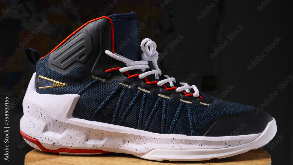 Dark basketball sneakers with white sole. Closeup. Sneakers provide