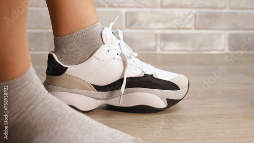 Stylish white sneakers with gray and black accents are the epitome of modern casual fashion. The clean, minimalist design makes them versatile for different occasions.