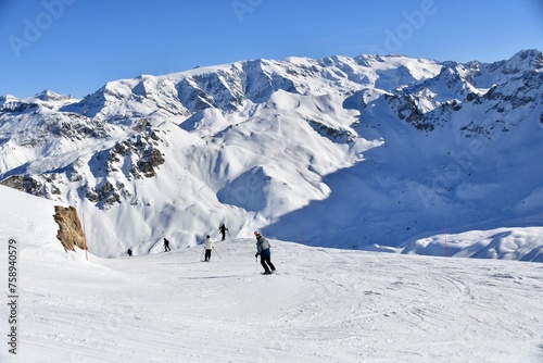 Skiers on the slopes of Courchevel ski resort, French alps.