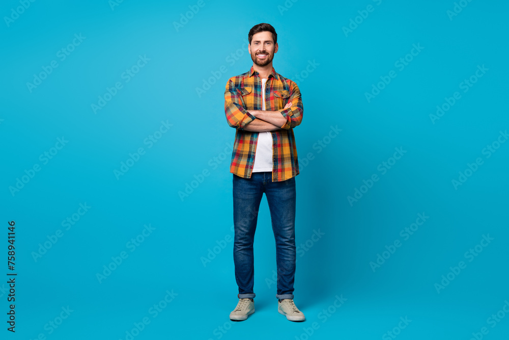 Full size photo of handsome young male crossed hands confident start up boss wear trendy plaid outfit isolated on blue color background Full size photo of handsome young male crossed hands confident start up boss wear trendy plaid outfit isolated on blue color background