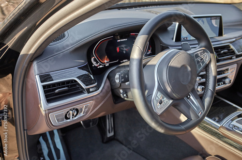 Shift lever, car steering wheel and sensors. Inside a modern car view, city car interior background © Studio-M