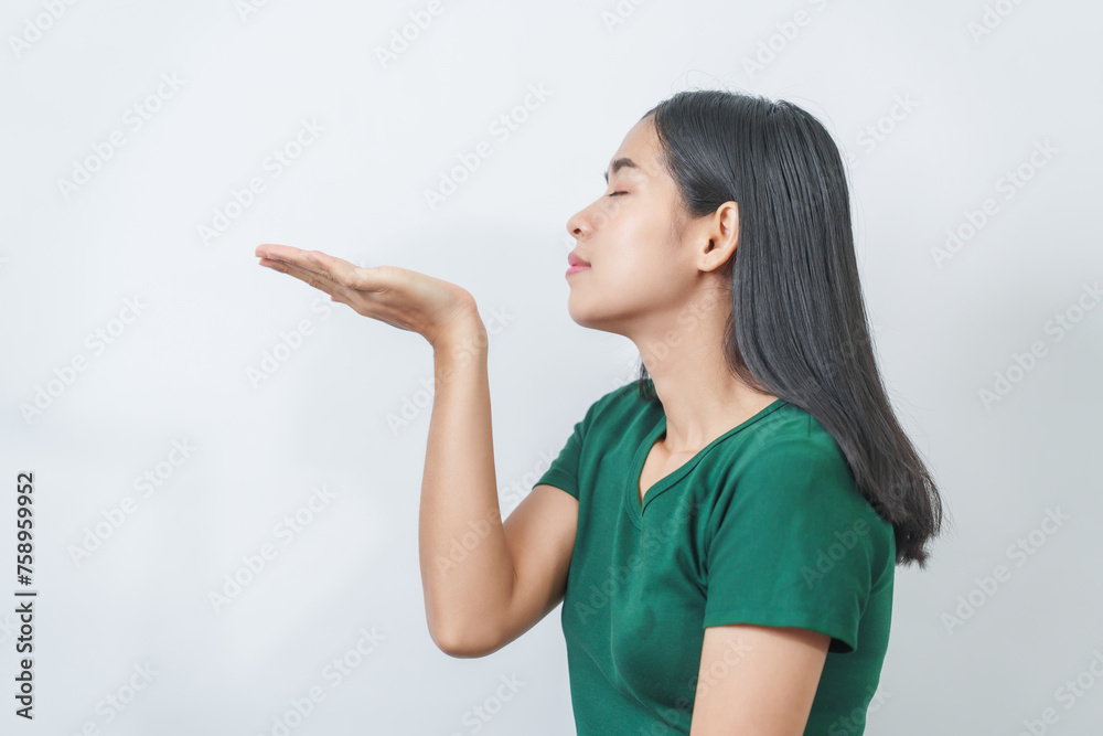 Happy and calm Asian girl is seen enjoying a pleasant aroma, taking deep breaths of fresh air in isolation. Happy and calm Asian girl is seen enjoying a pleasant aroma, taking deep breaths of fresh air in isolation.