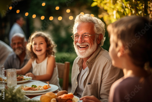Inter-Generational Joy  Senior Grandfather Enjoying Outdoor Feast  Engaging Kids at Garden Dinner Party.  Family Gathering  Mature Man Bonding with Grandchildren