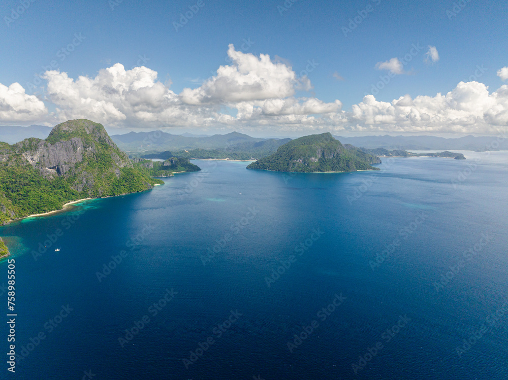 Cadlao Island surrounded by blue sea, drone view. Blue sky and clouds. El Nido, Palawan. Philippines.