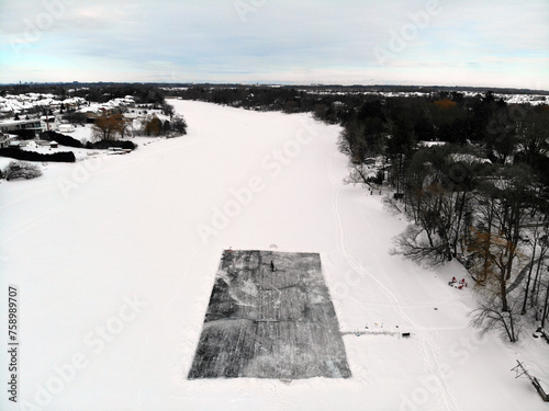 Aerial view of a s skating rink on a frozen river in mid-winter