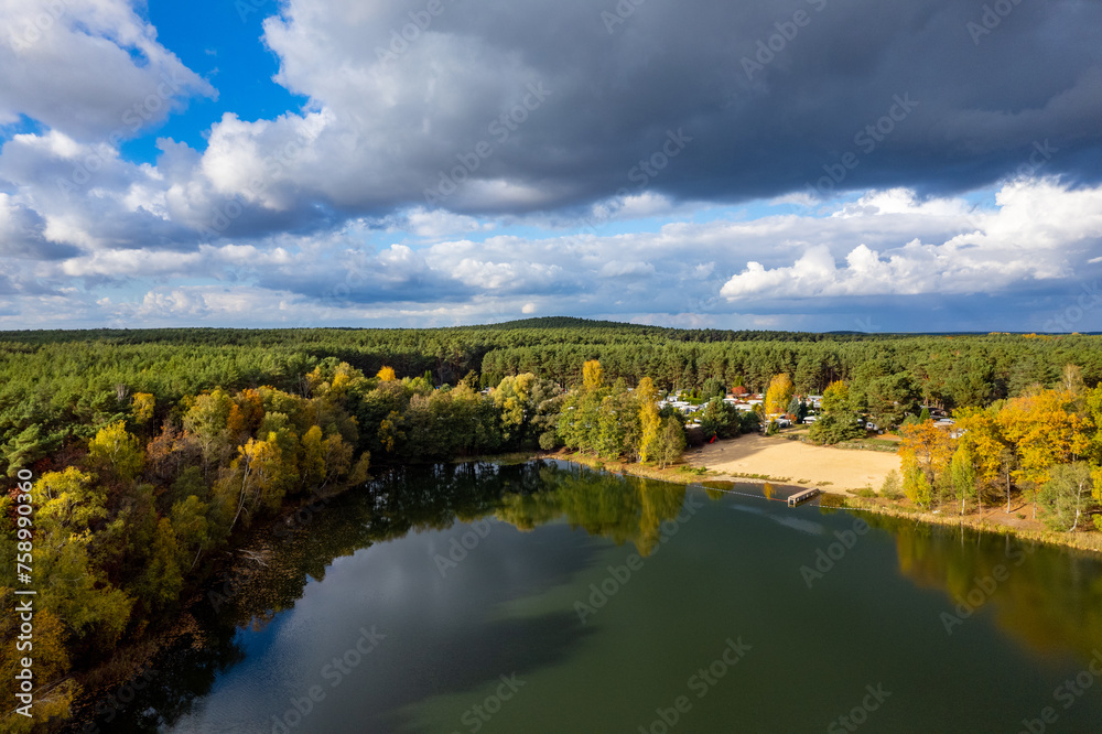 Aerial shot of beautiful lake surrounded by forest in a calm autumn day. Germany. Aerial shot of beautiful lake surrounded by forest in a calm autumn day. Germany.