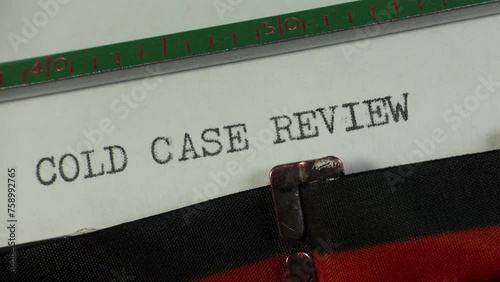 Report of a police investigation into an old crime. Typing Cold Case Review on an old manual typewriter.
