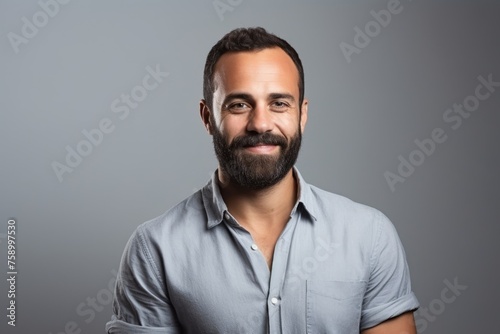 Portrait of a handsome man with beard and mustache over grey background