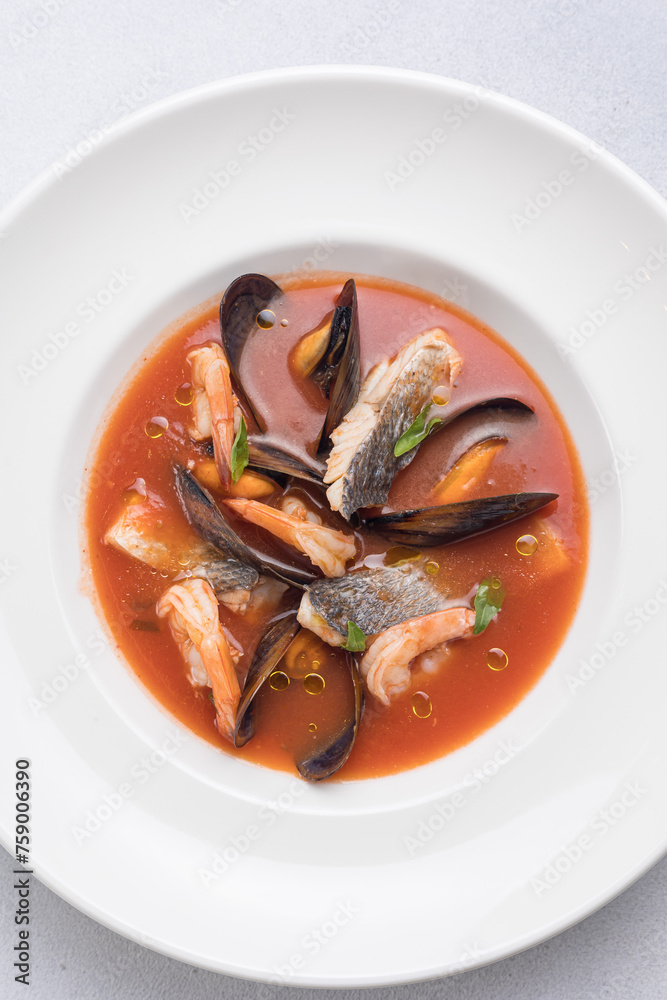 Seafood soup with salmon and mussels in a white plate Seafood soup with salmon and mussels in a white plate