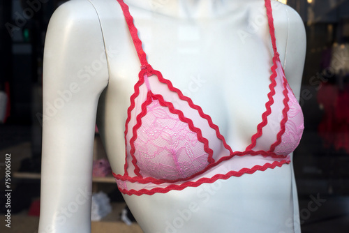 Closeup of red and pink bra on mannequin in a fashion store showroom