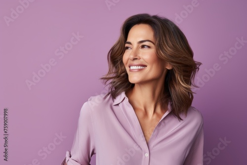 Portrait of happy smiling business woman in pink shirt, over purple background
