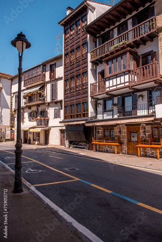 a traditional house with wooden balconies in Spain. A street in the fishing town of Orio in Spain