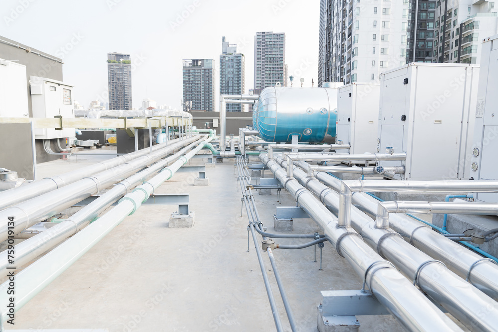 Water pipes system and hot water boiler system tank at rooftop of building. Hot water buffer tank network system on the building rooftop