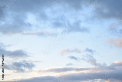 light blue sky with gray clouds