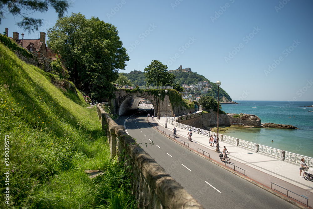 Obraz premium Motorway, a motorway along the beach in the resort town of San Sebastian, Spain. The road to Donostia, San Sebastian. The concept of an affordable holiday in Spain.
