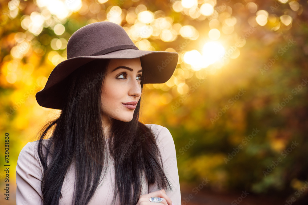 Autumn photoshoot of adorable young woman in hat. A harmonious blend of style and the natural world