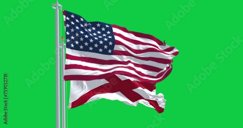 Alabama and the United States flags waving isolated on green background photo