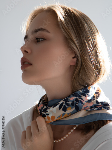 fashion photo of beautiful young woman looking like elegant lady. Beautiful girl, fashion and beauty. White shirt and scarf, French style. Clean skin and daytime makeup. Lovely model