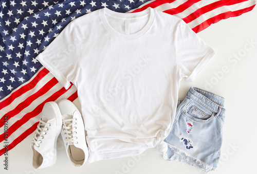 White T Shirt Mockup with 4th of July American Background. Blank t shirt mock up. Copy space blank white t-shirt flat lay . USA tshirt mock up photo