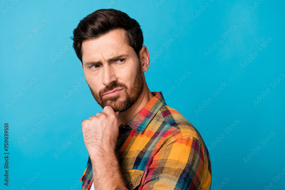 Photo of brutal dissatisfied man with beard dressed stylish plaid shirt look at proposition empty space isolated on blue color background Photo of brutal dissatisfied man with beard dressed stylish plaid shirt look at proposition empty space isolated on blue color background