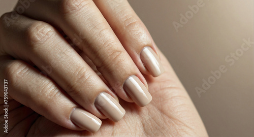 Female Hand with Beige Manicure on Shiny Background for Nail Care Advertisement