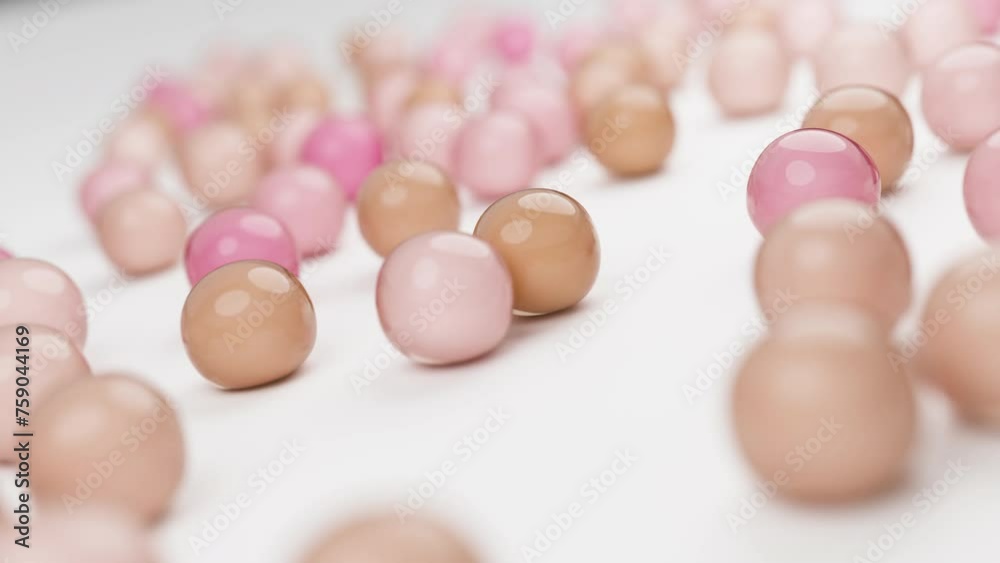 Multicolored balls drop, bounce on a plate. Each bounce signifies collagen, elastin in youthful skin, preventing sagging, wrinkles. Visual metaphor for skin's firmness, elasticity. Multicolored balls drop, bounce on a plate. Each bounce signifies collagen, elastin in youthful skin, preventing sagging, wrinkles. Visual metaphor for skin's firmness, elasticity.