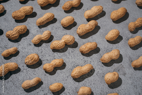 peanuts closed on a gray concrete background, lots of nuts, top and side view