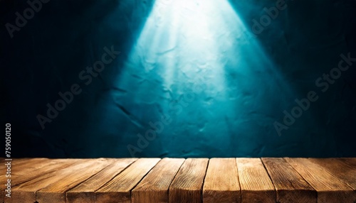 empty wooden table on the background of an empty dark wall with focal light for the montage of your project