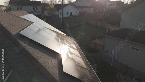 Flying over solar panels installed on the roof of residential home photo