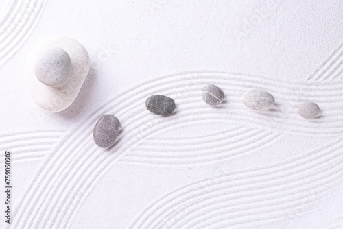 Canvas Print Zen garden stones on white sand with pattern, flat lay