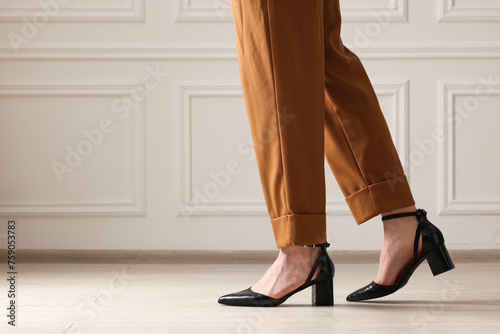 Businesswoman in elegant leather shoes indoors, closeup. Space for text