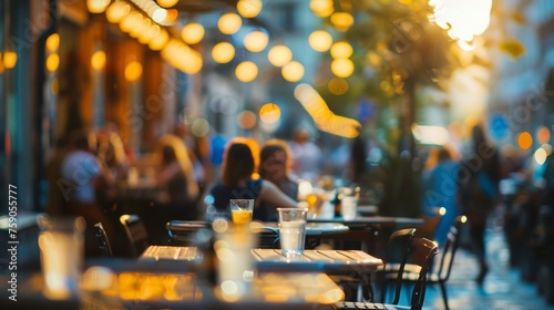 A cozy street cafe setup, capturing the warm glow of hanging lights with unfocused patrons in the background