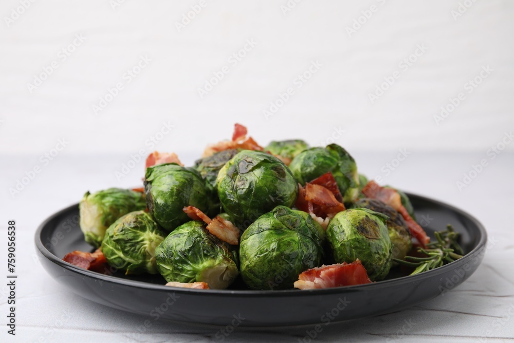 Obraz premium Delicious roasted Brussels sprouts, bacon and rosemary on white textured table, closeup