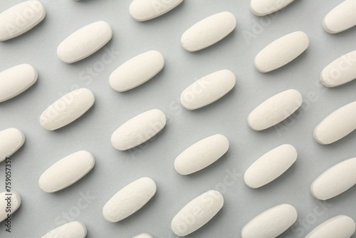 Vitamin pills on light grey background, flat lay. Health supplement