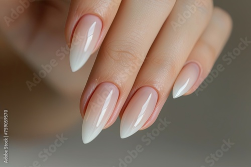 Close up of pearl colored stiletto nails on a woman s hand