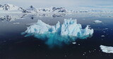 Global warming problem: iceberg melting at polar ocean bay aerial. Nature preserve and environment conservation of land of snow and ice. Climate change of Antarctica. Arctic landscape drone shot