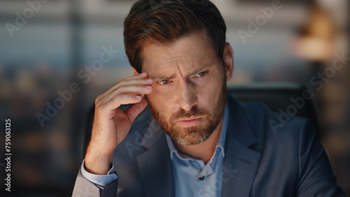 Worried boss thinking face at evening cabinet closeup. Upset man pondering task