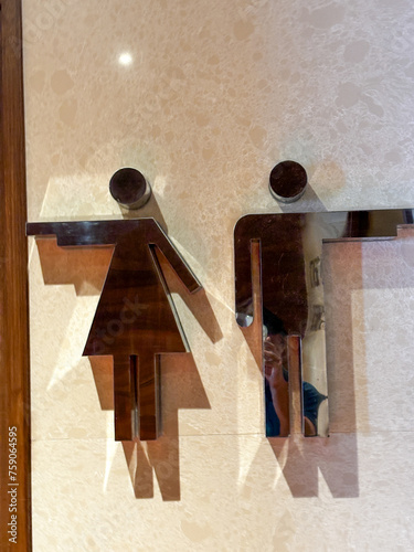 Two men and a woman are depicted on a wall in a bathroom