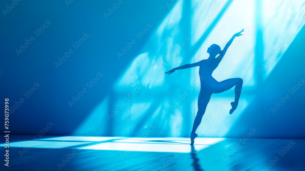 Graceful silhouette of a ballerina in blue light