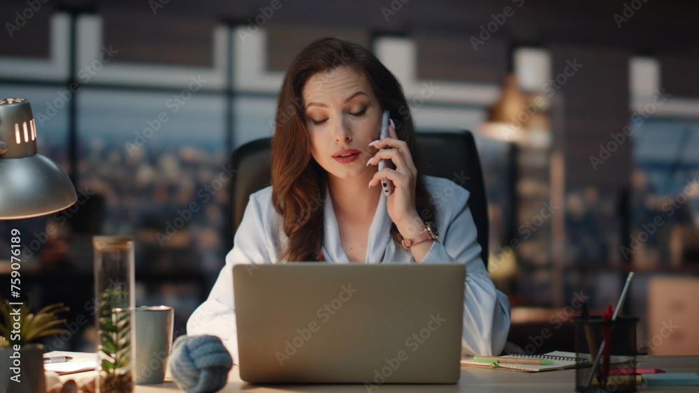 Business woman speaking smartphone at night workplace. Calling lady making notes Business woman speaking smartphone at night workplace. Calling lady making notes