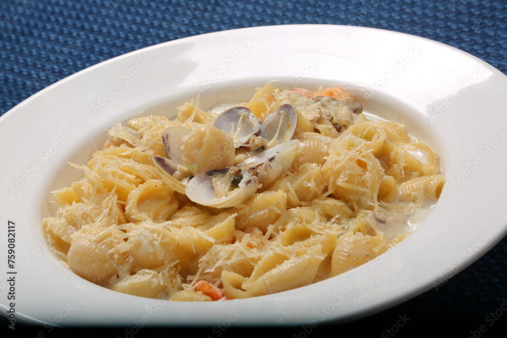 Orecchiette pasta with clam, creamy sauce and dill. Healthy food. on restaurant table Orecchiette pasta with clam, creamy sauce and dill. Healthy food. on restaurant table