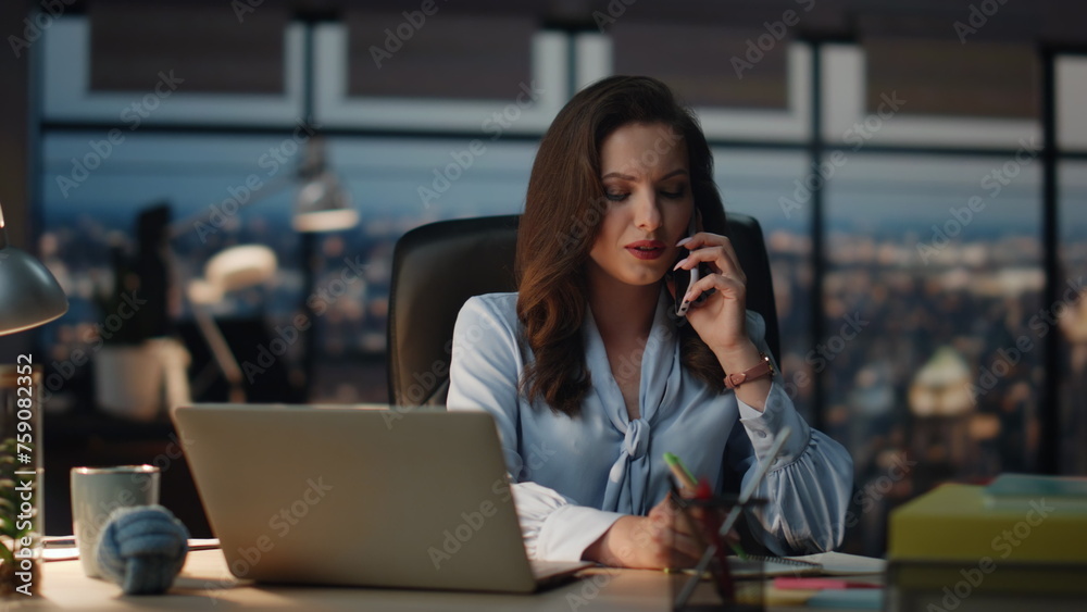 Confident lady talking mobile phone call at evening view office. Manager writing Confident lady talking mobile phone call at evening view office. Manager writing
