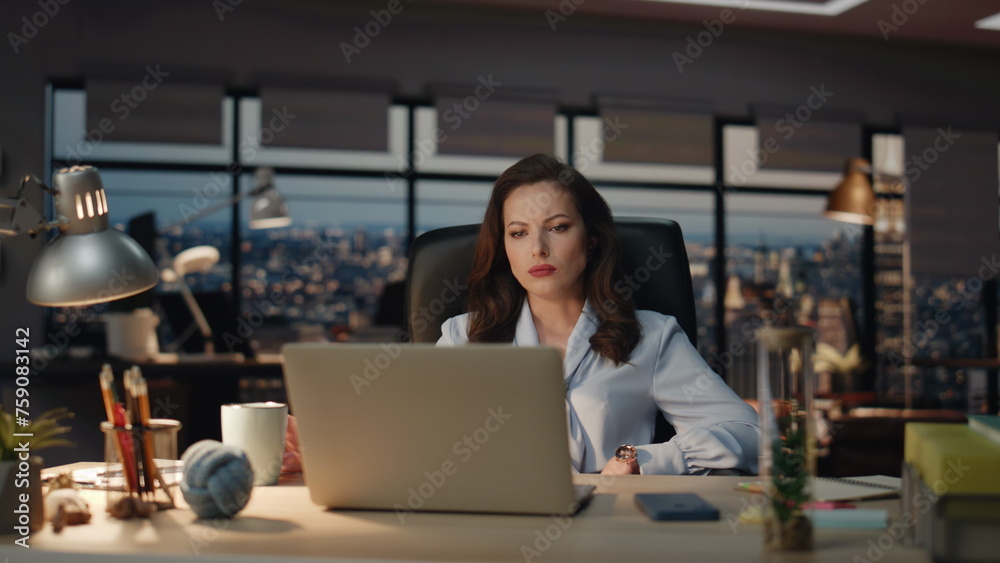 Woman workaholic staying late dark office closeup. Tired businesswoman working Woman workaholic staying late dark office closeup. Tired businesswoman working