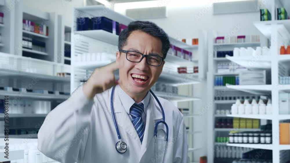Close Up Of Asian Male Doctor With Stethoscope Shouting To Camera While Standing In Pharmacy