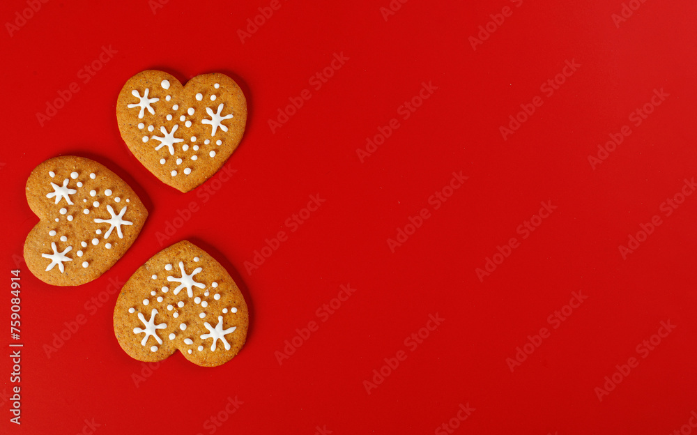 Fototapeta premium beautiful hand-baked cookies in the shape of a heart on a red background