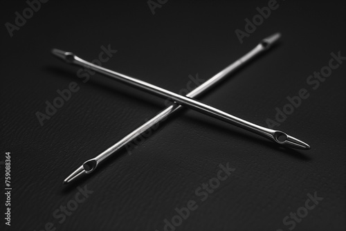2 crossed large eye sewing needles on a black background.AI generated photo