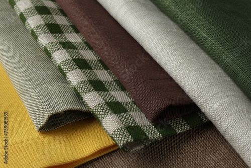 Many different fabrics on brown cloth, closeup