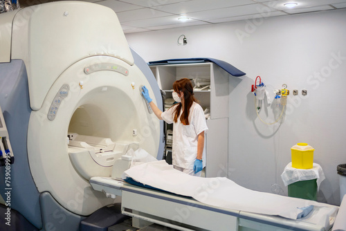 Female doctor turning on CT machine