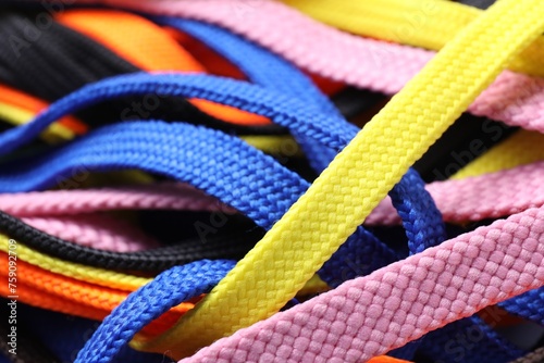 Many colorful shoe laces as background, closeup